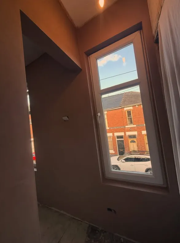 Smooth plaster around a tall window